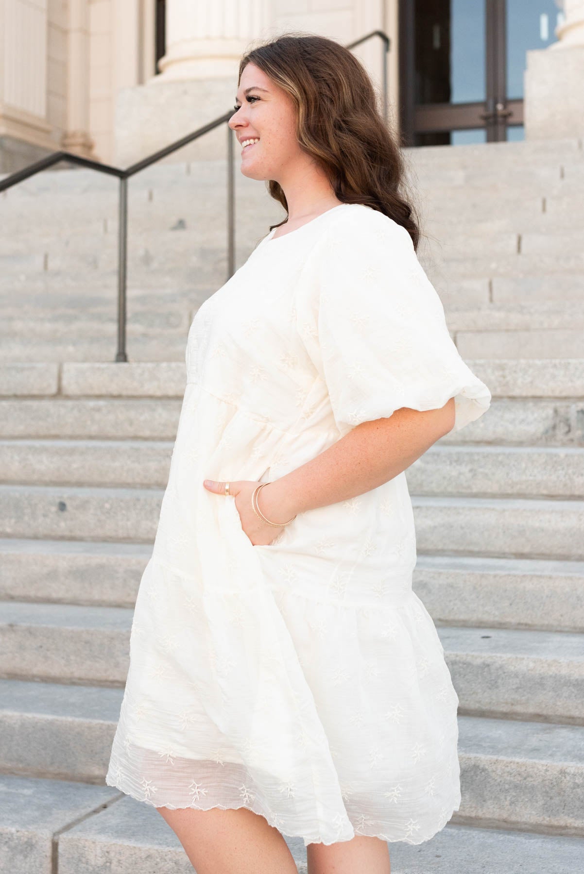 Side view of the cream floral puff sleeve dress