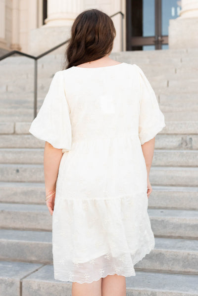 Back view of the cream floral puff sleeve dress