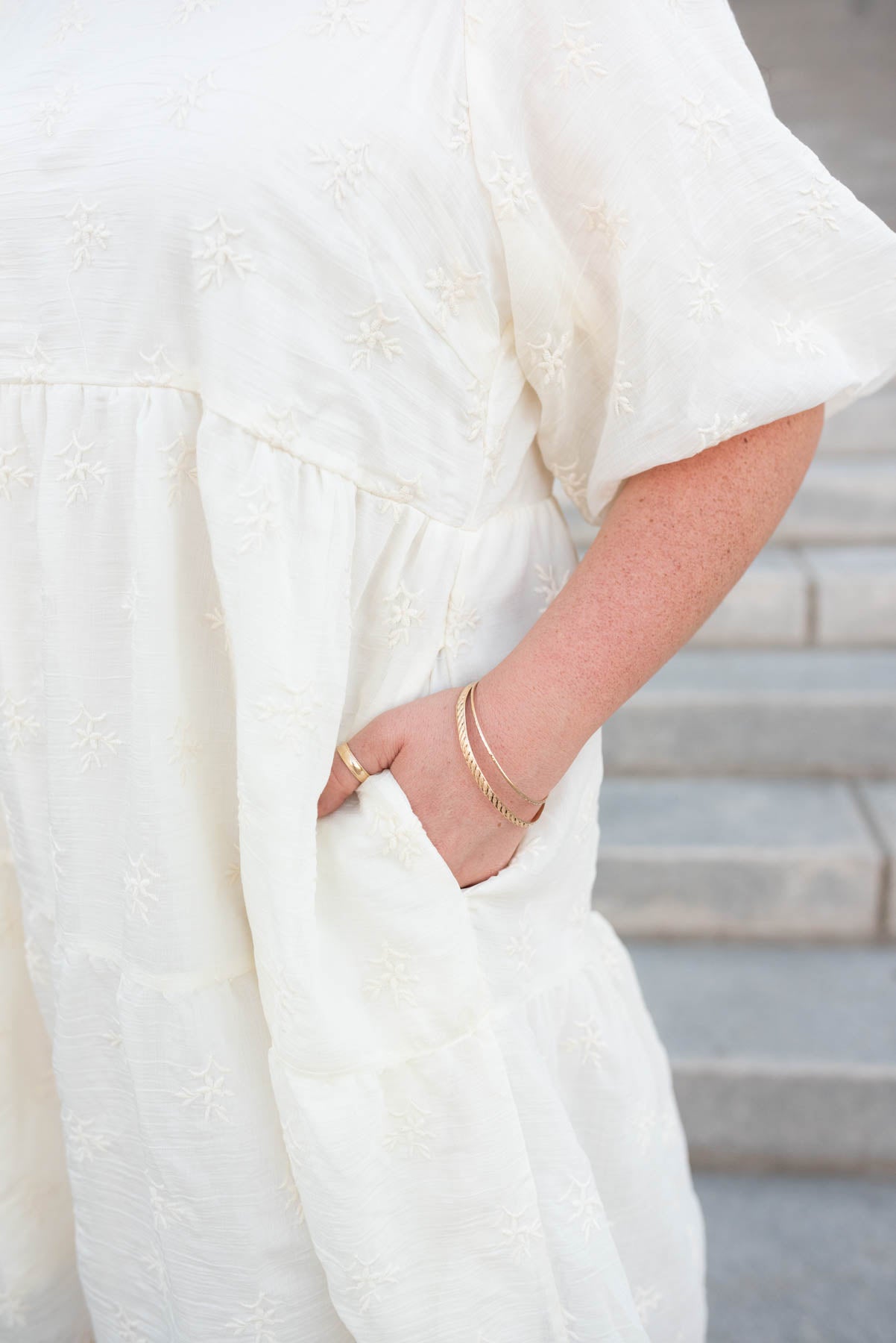 Close up of the fabric on  the cream floral puff sleevee dress