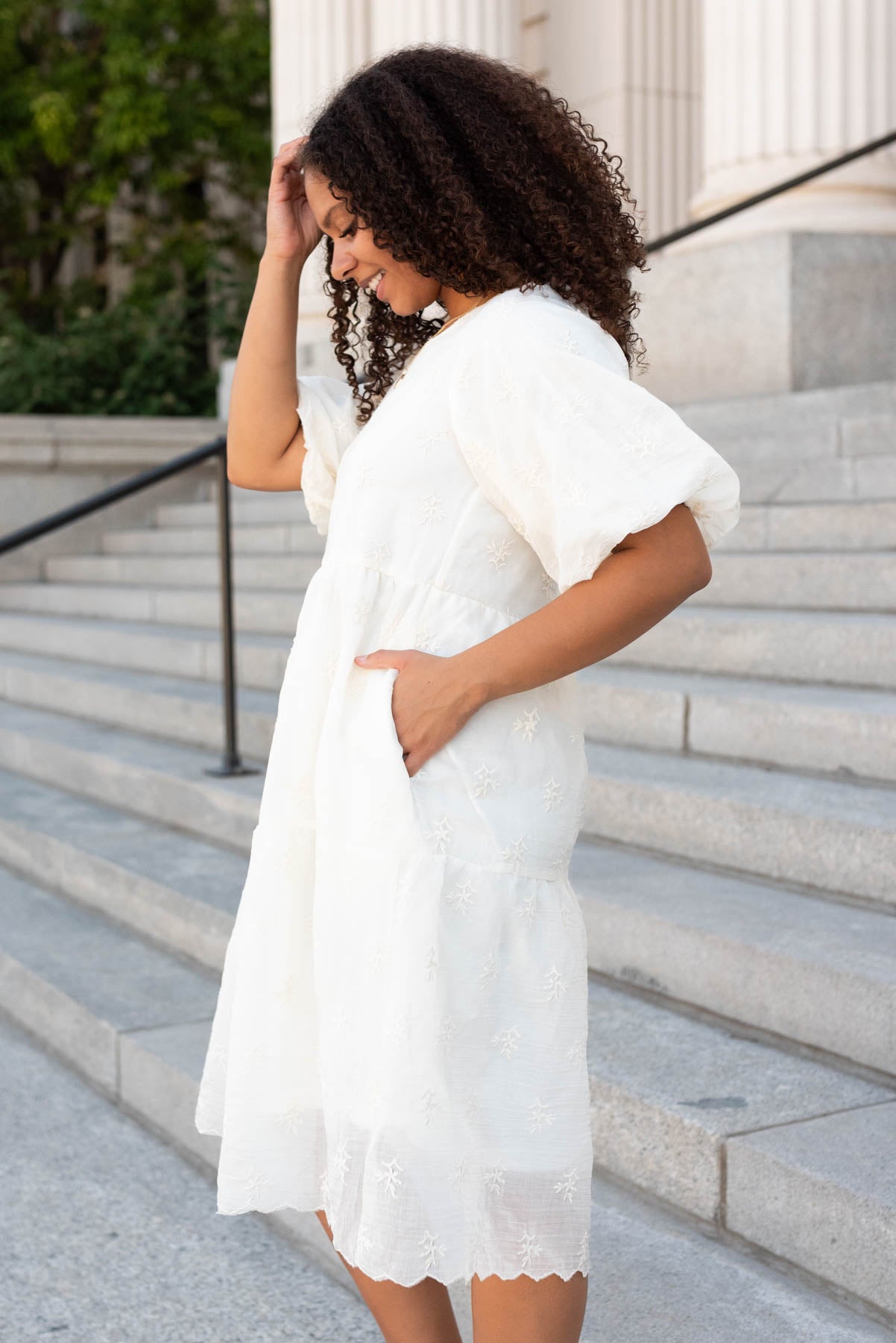 Side view of the cream floral puff sleeve dress