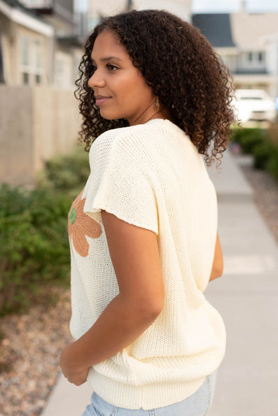 Side view of the cream floral sweater