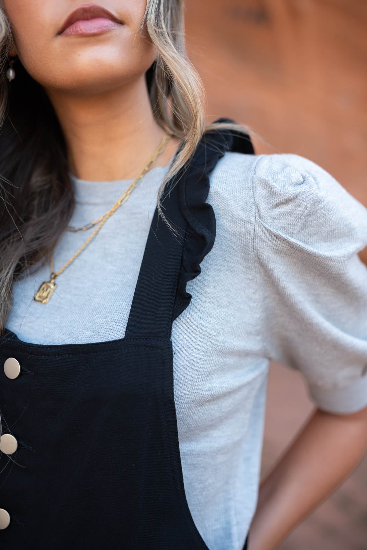 Close up of the strap of a black jumpsuit