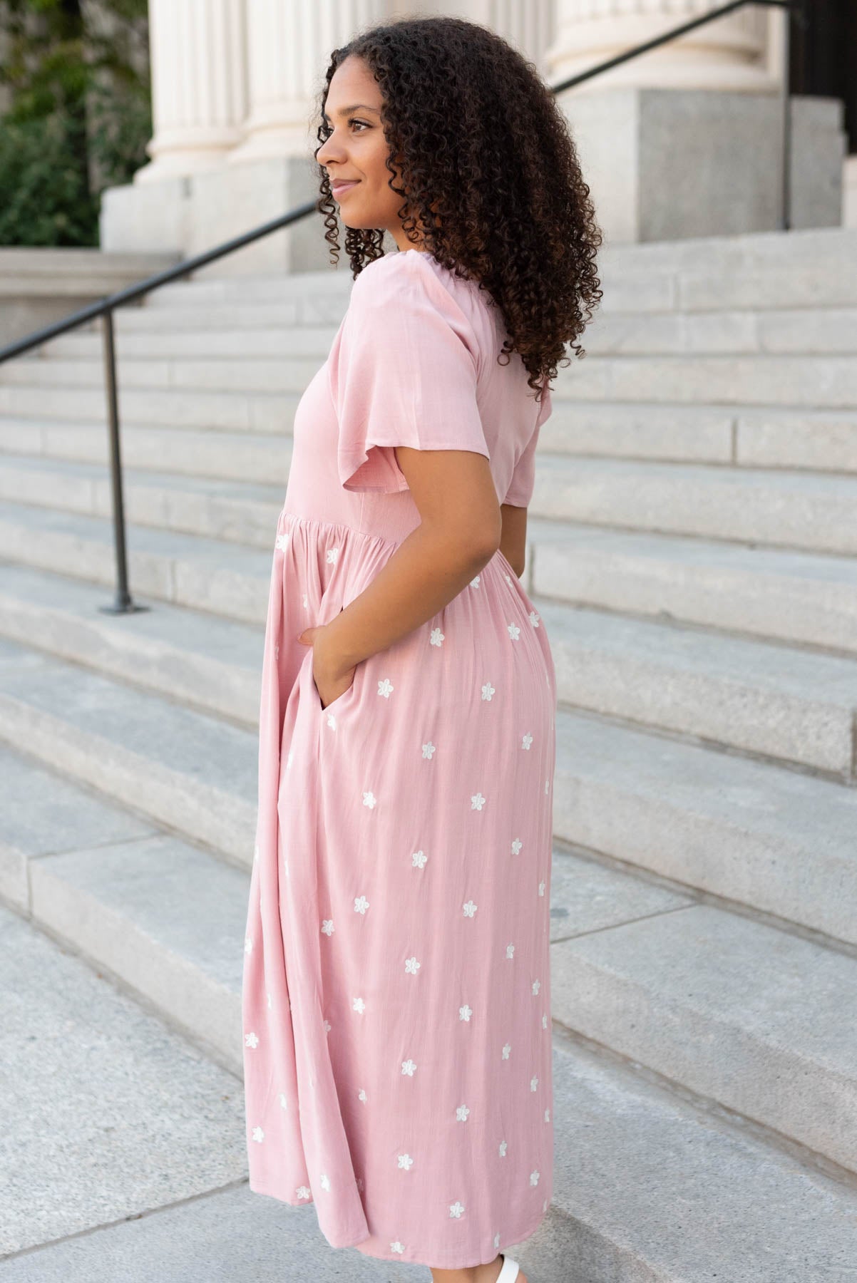 Side view of the blush embroidered dress