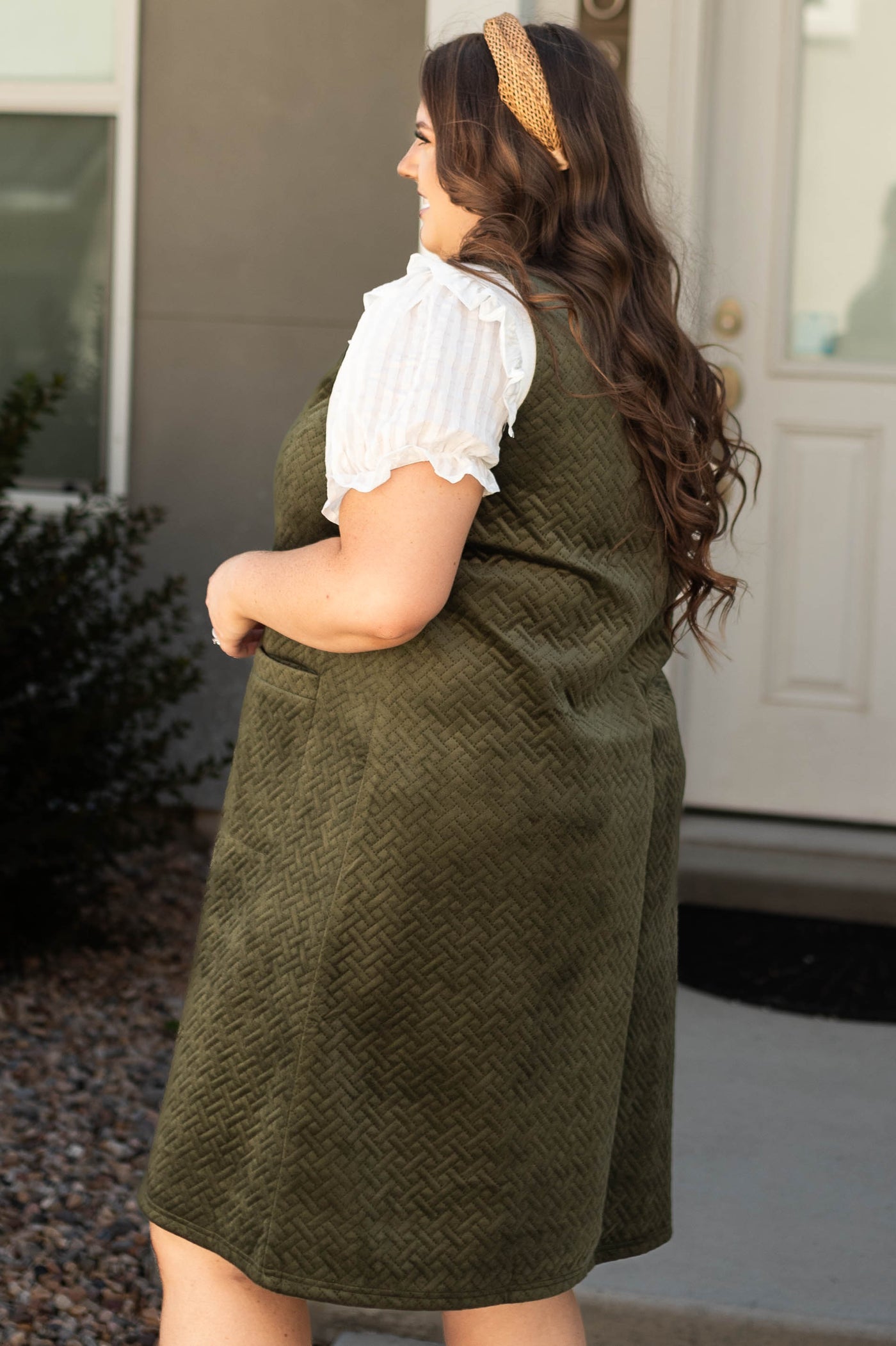 Side view of a plus size olive dress