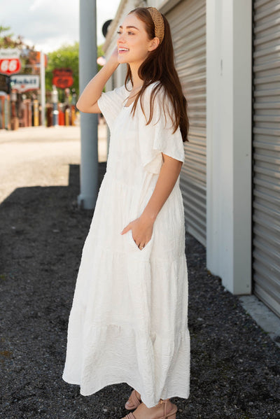 Side view of the white woven pattern dress