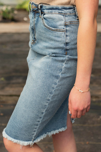 Side view of the indigo distressed skirt