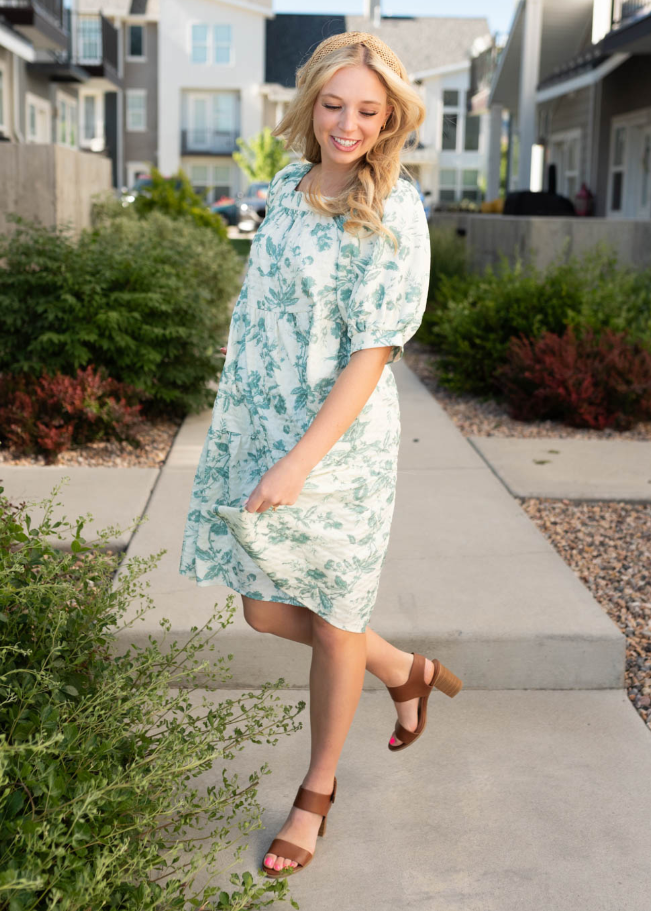 Side view of the short sleeve green floral tiered dress