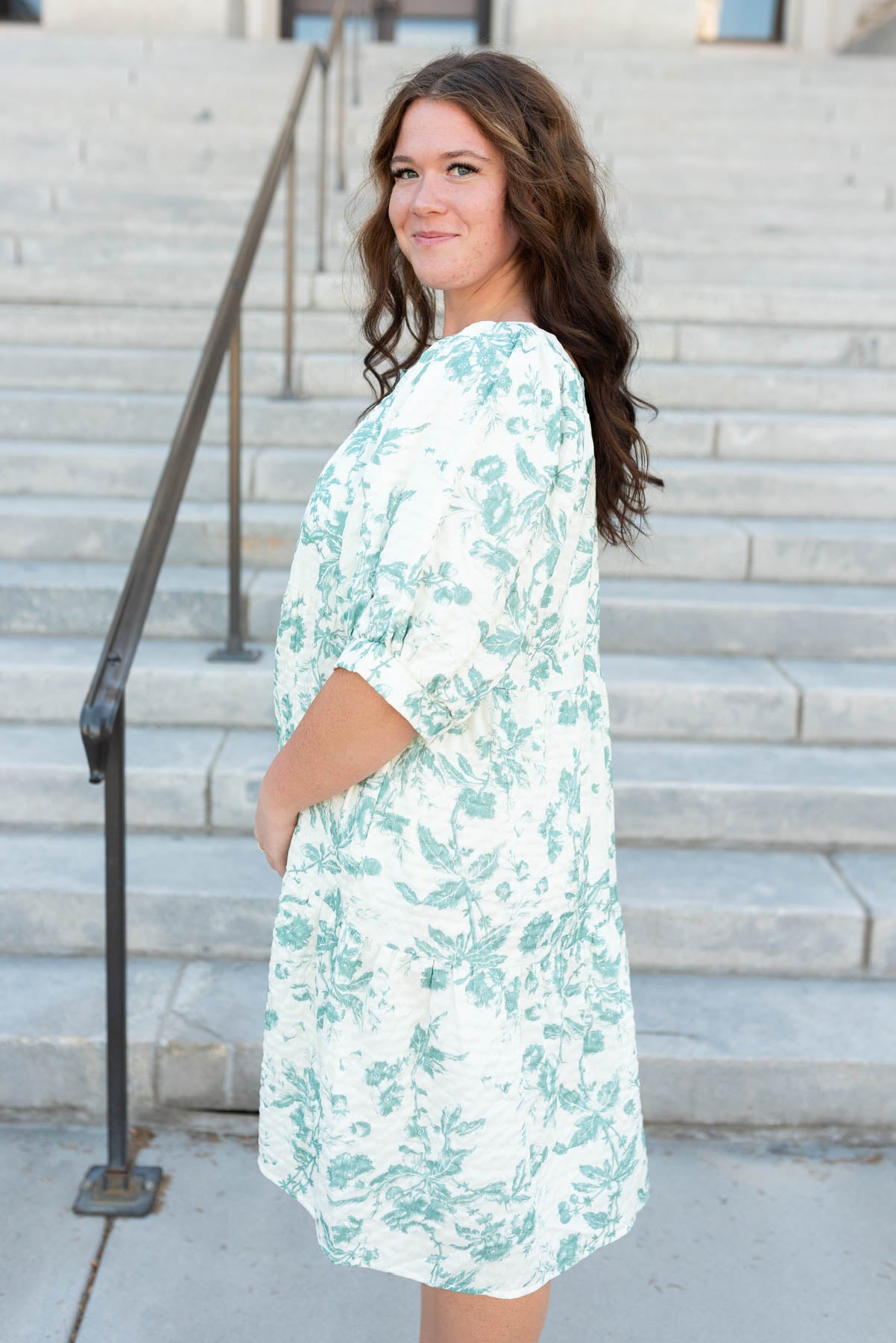 Side view of the plus size green floral tiered dress