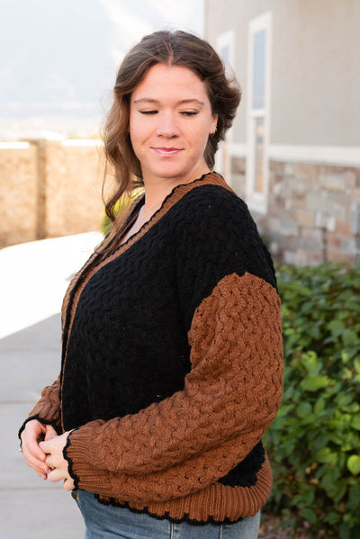 Side view of the plus size black knit cardigan