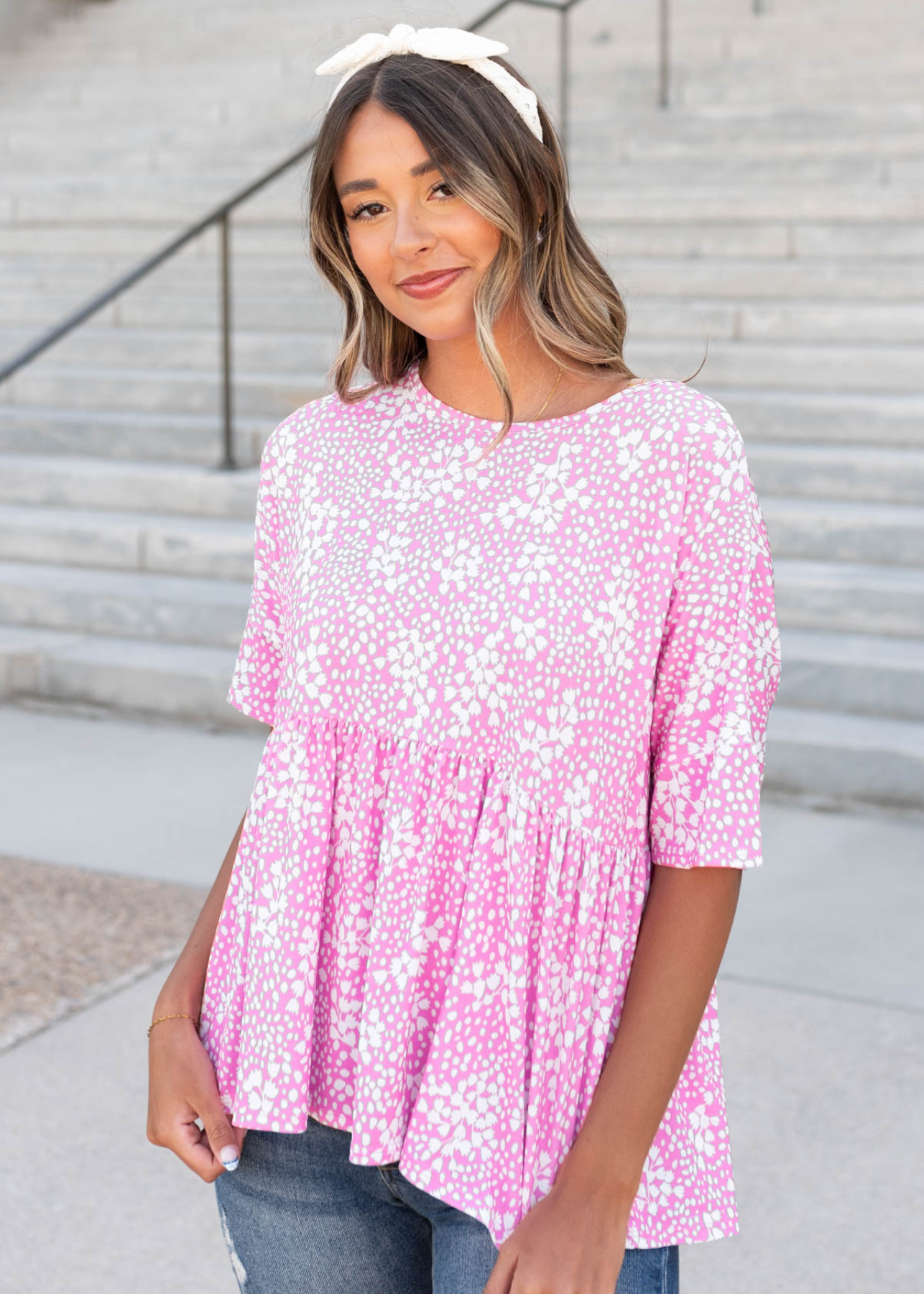 Pink floral peplum top with white flowers