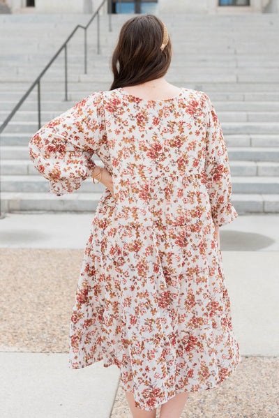 Back view of the cream floral tiered dress in plus size