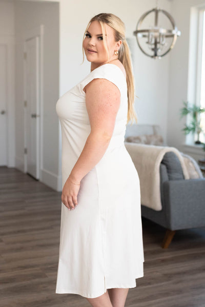 Side view of a plus size white slipette midi cap sleeve