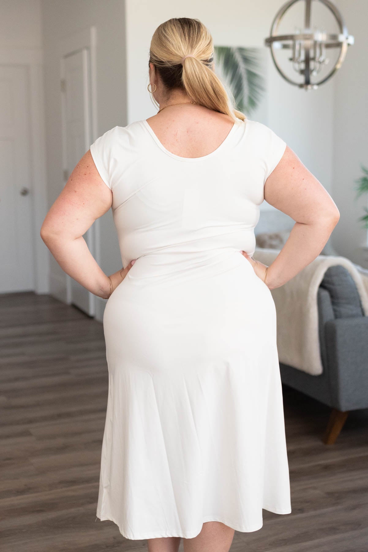 Back view of a white plus size slipeete midi cap sleeve