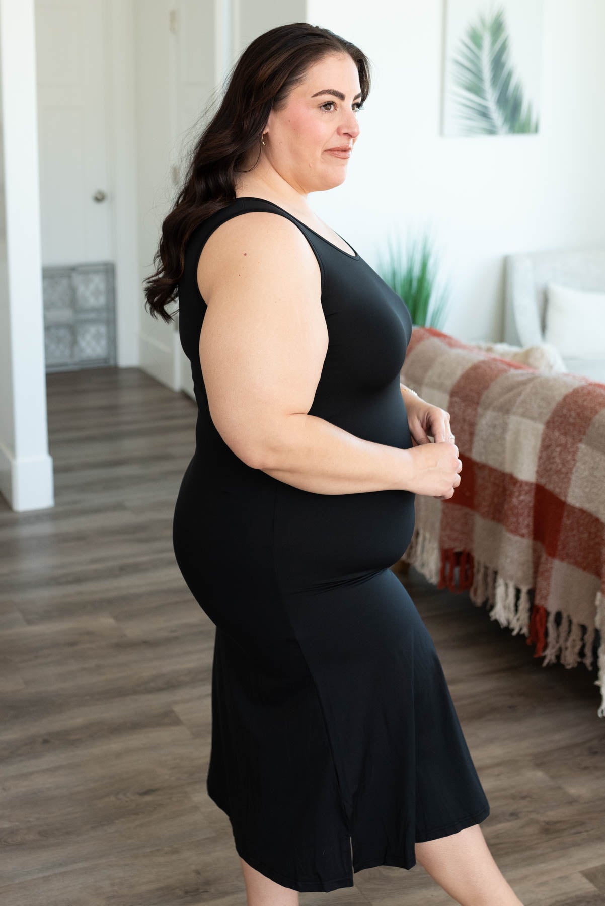 Side view of the plus size black slipette midi tank