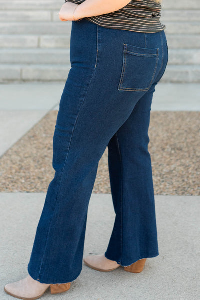 Side view of the plus size dark denim wide leg pants