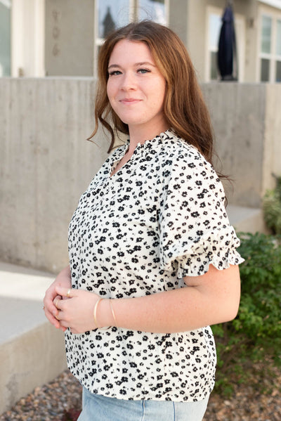 Side view of the black floral top