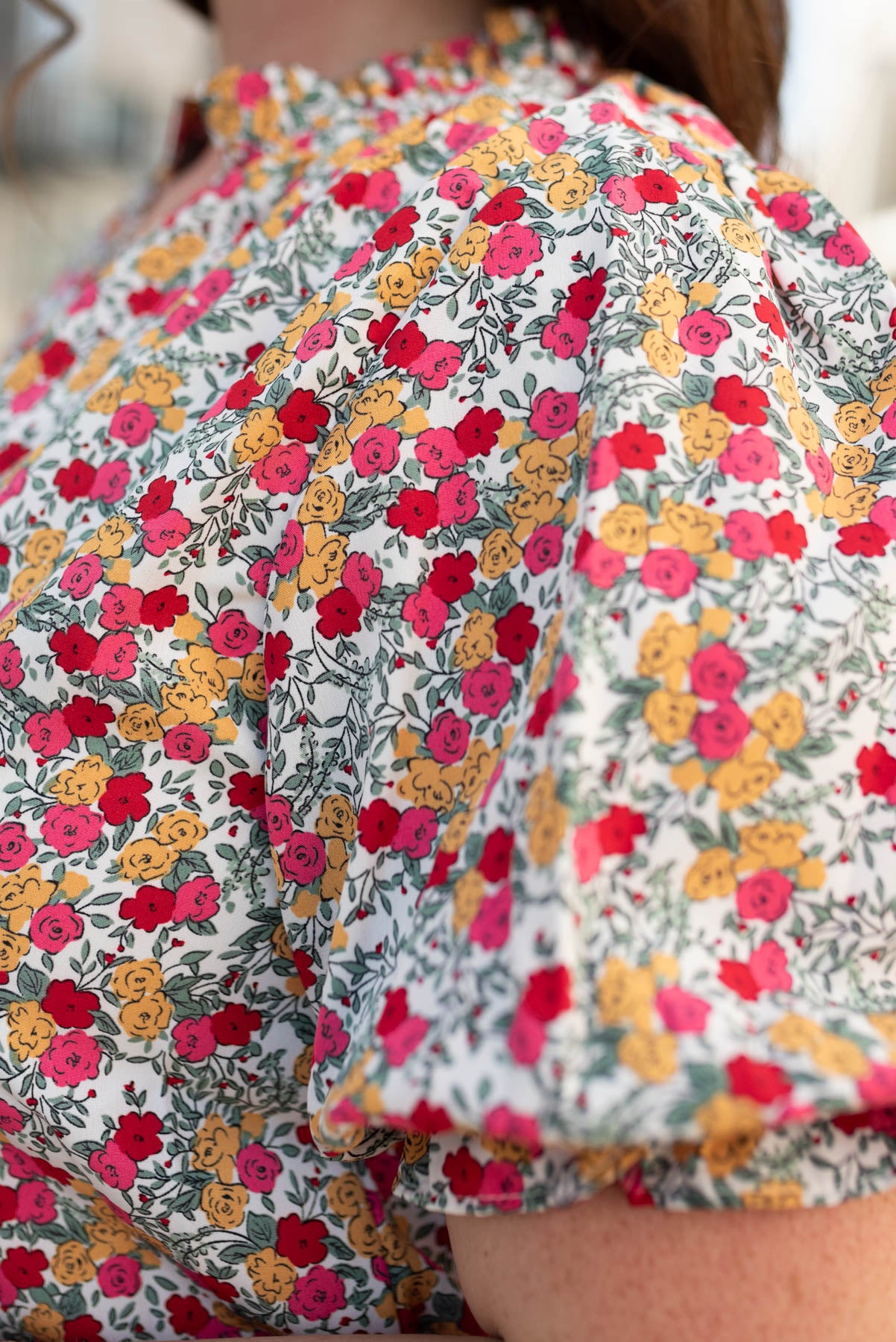 Close up of the sleeve and fabric on the plus size white floral top