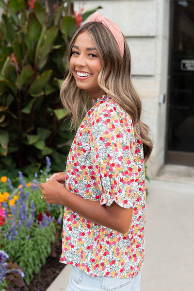 Side view of the white multi floral top