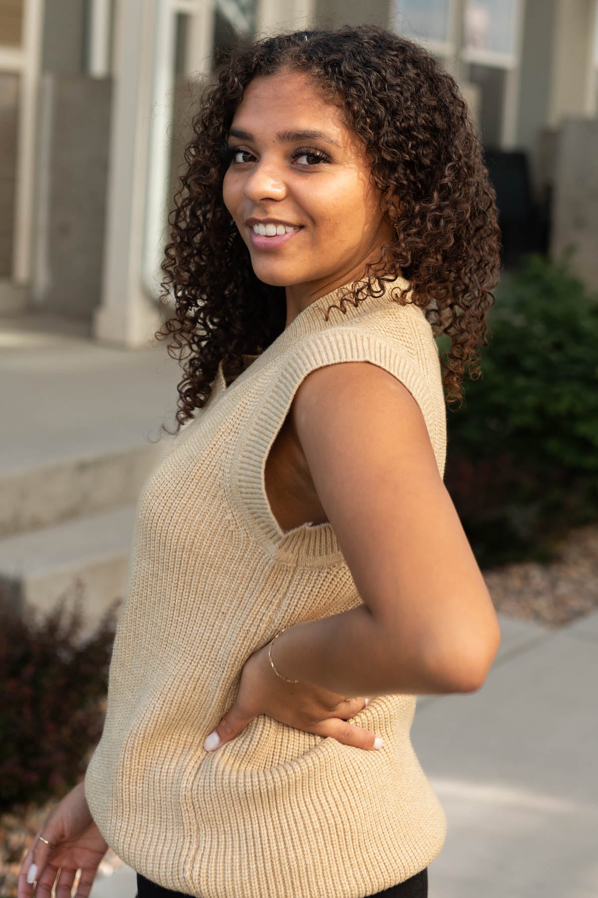 Side view of a camel sweater vest