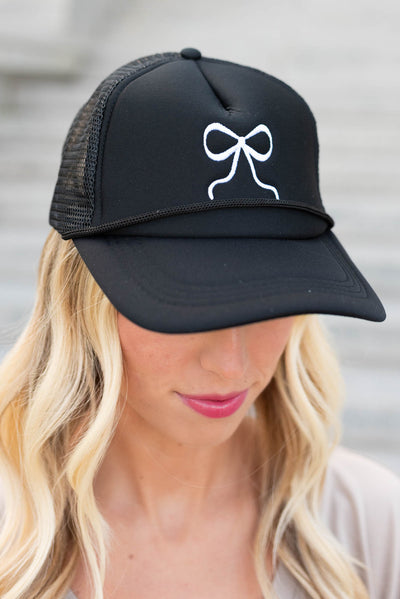 Close up of the black embroidered bow hat