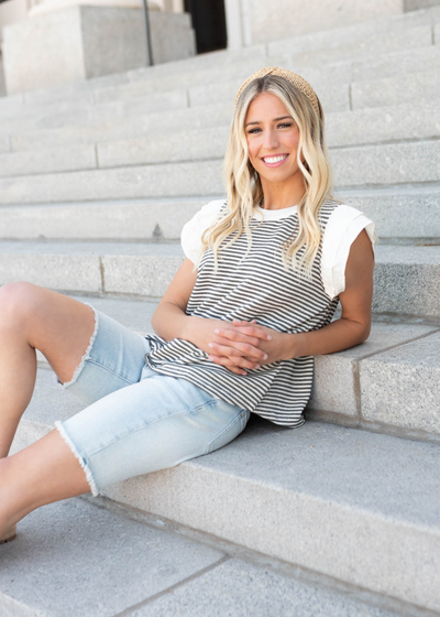 Black stripe knit top with white ruffle sleeves