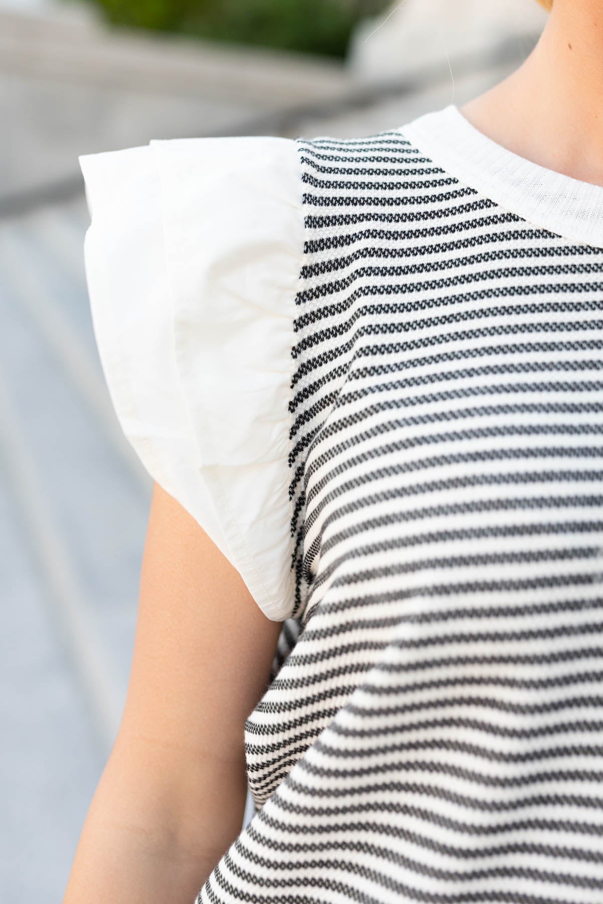 Close up of the sleeves on the black stripe knit top