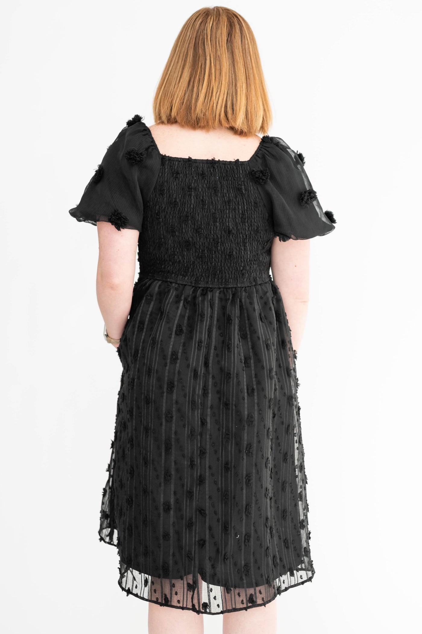 Back view of a medium black dress