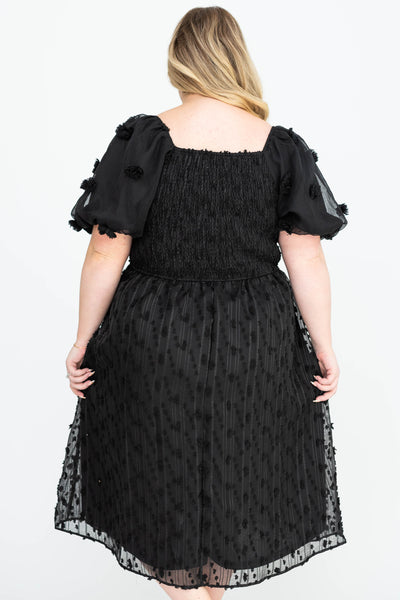 Back view of a plus size black dress