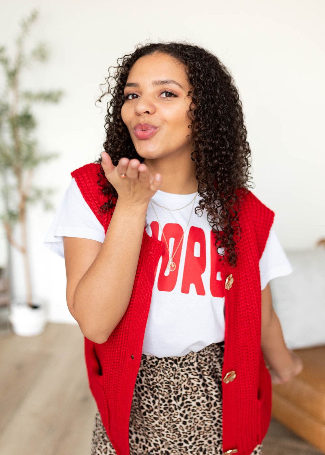 Red knit sweater vest with buttons and pockets