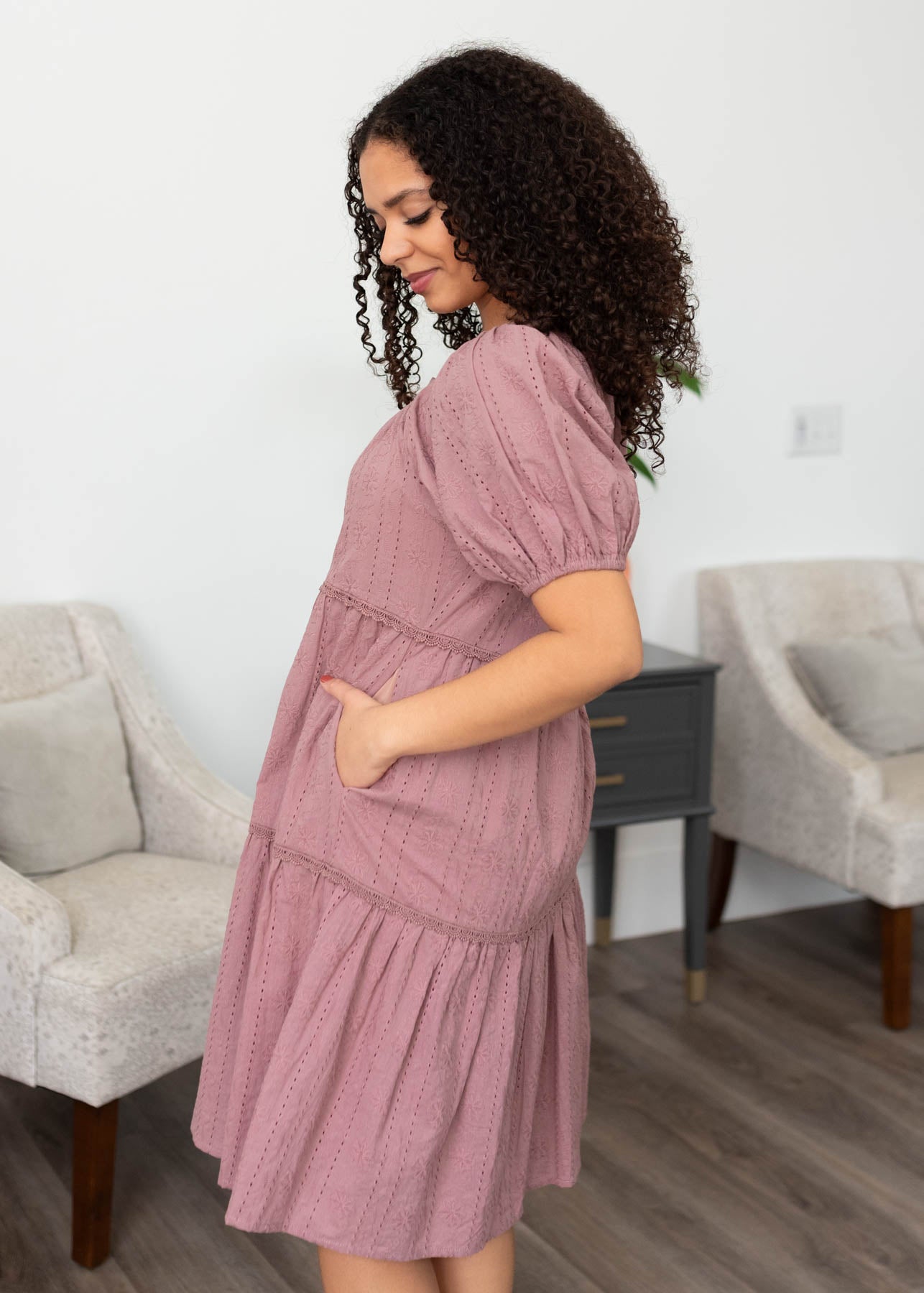 Side view of the dusty mauve embroidered dress with pockets