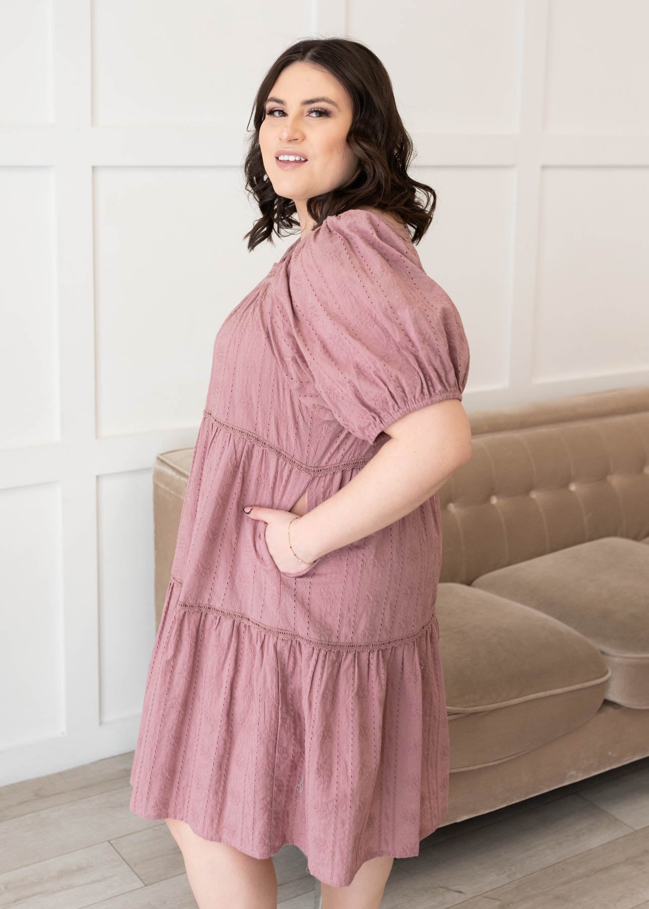 Side view of the plus size dusty mauve embroidered dress with pockets