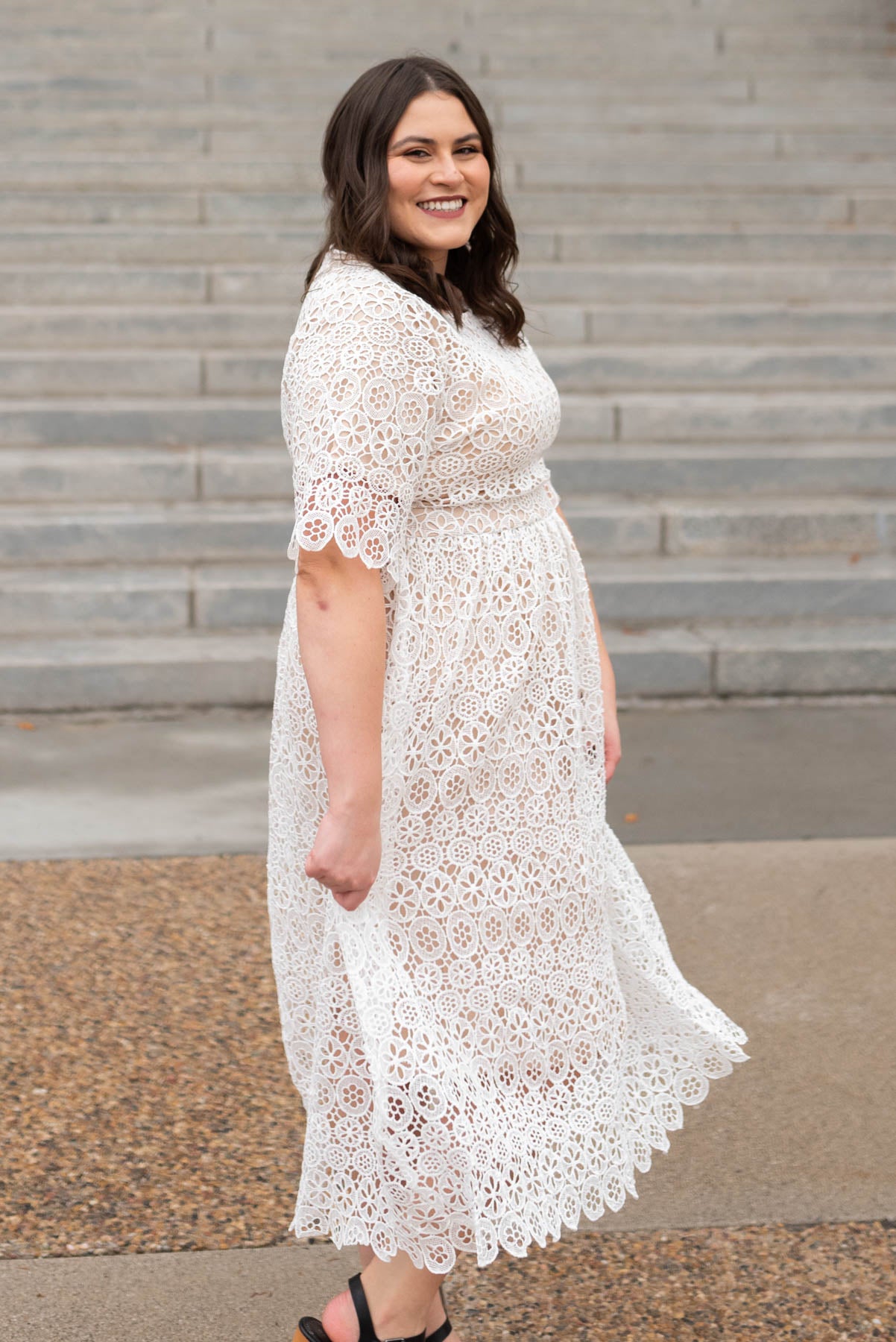 Side view of a short sleeve ivory lace dress