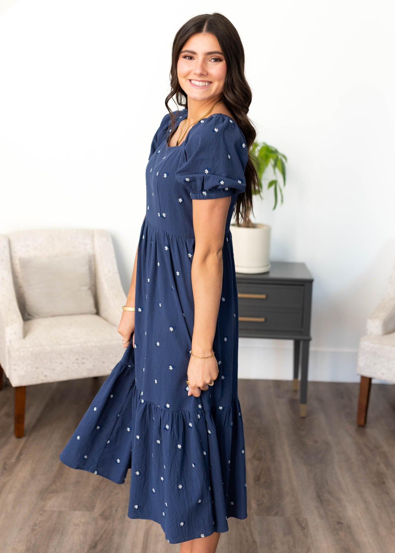 Side view of the navy embroidered floral dress