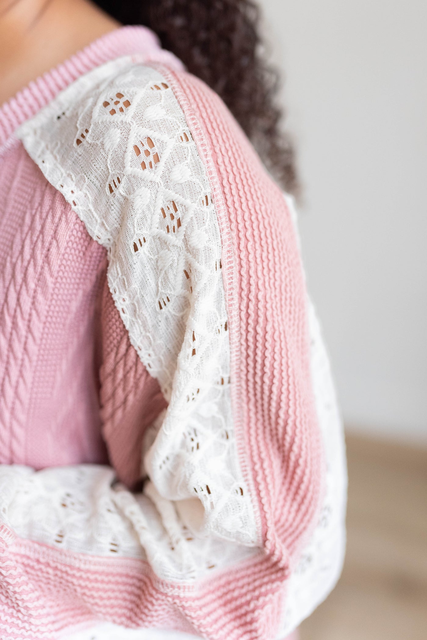 Close up of the lace on the mauve lace sleeve pullover