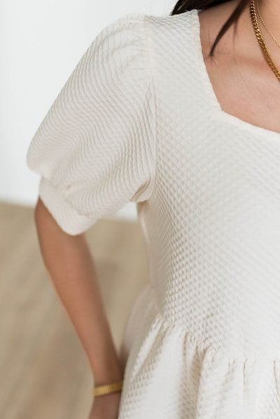 Close up of the fabric on the cream ruffle top