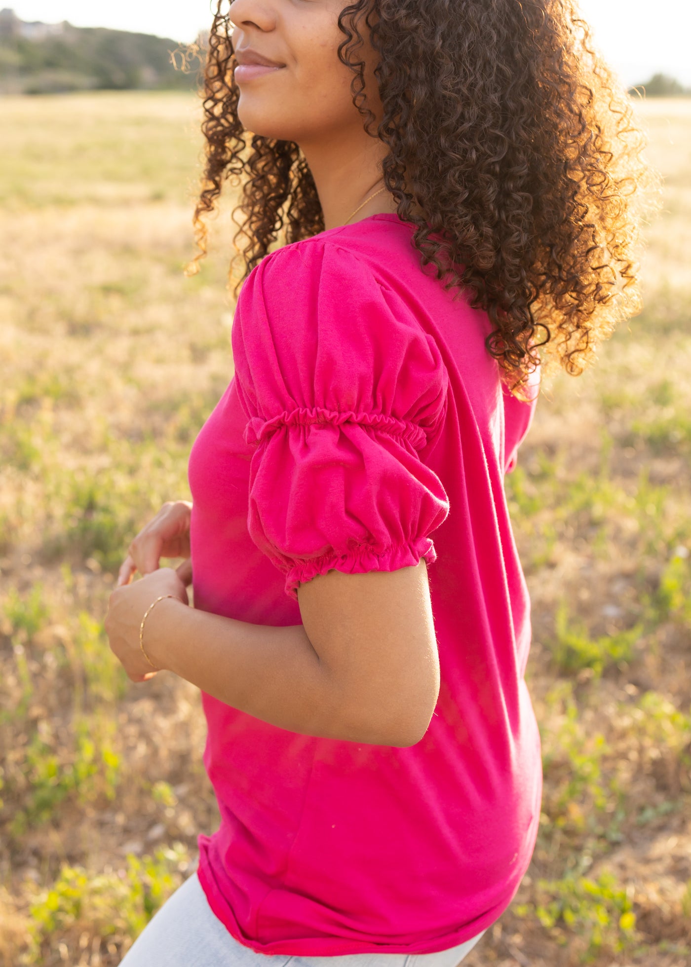 Side view of a dark fuchsia top