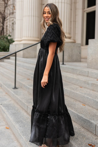 Side view of a black organza dress