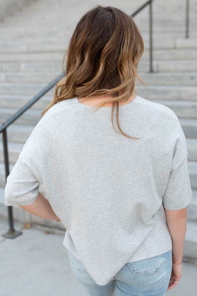 Back view of the heather grey v-neck top