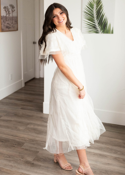 Side view of the cream sheer ruffle dress