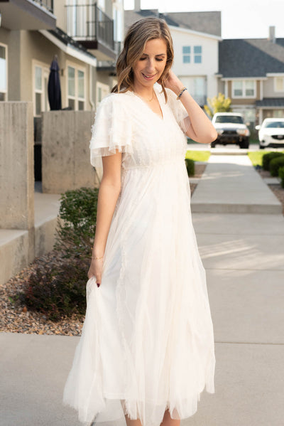 Side view of the cream sheer ruffle dress