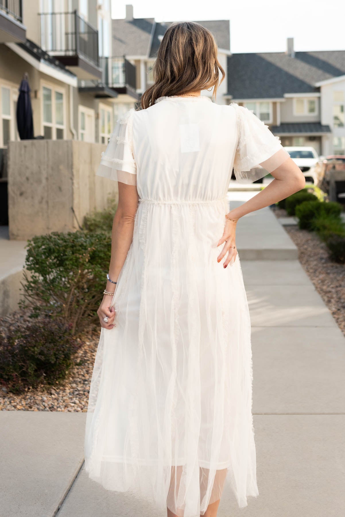 Back view of the cream sheer ruffle dress