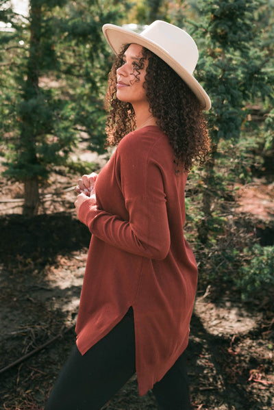 Side view of the dark rust v-neck sweater