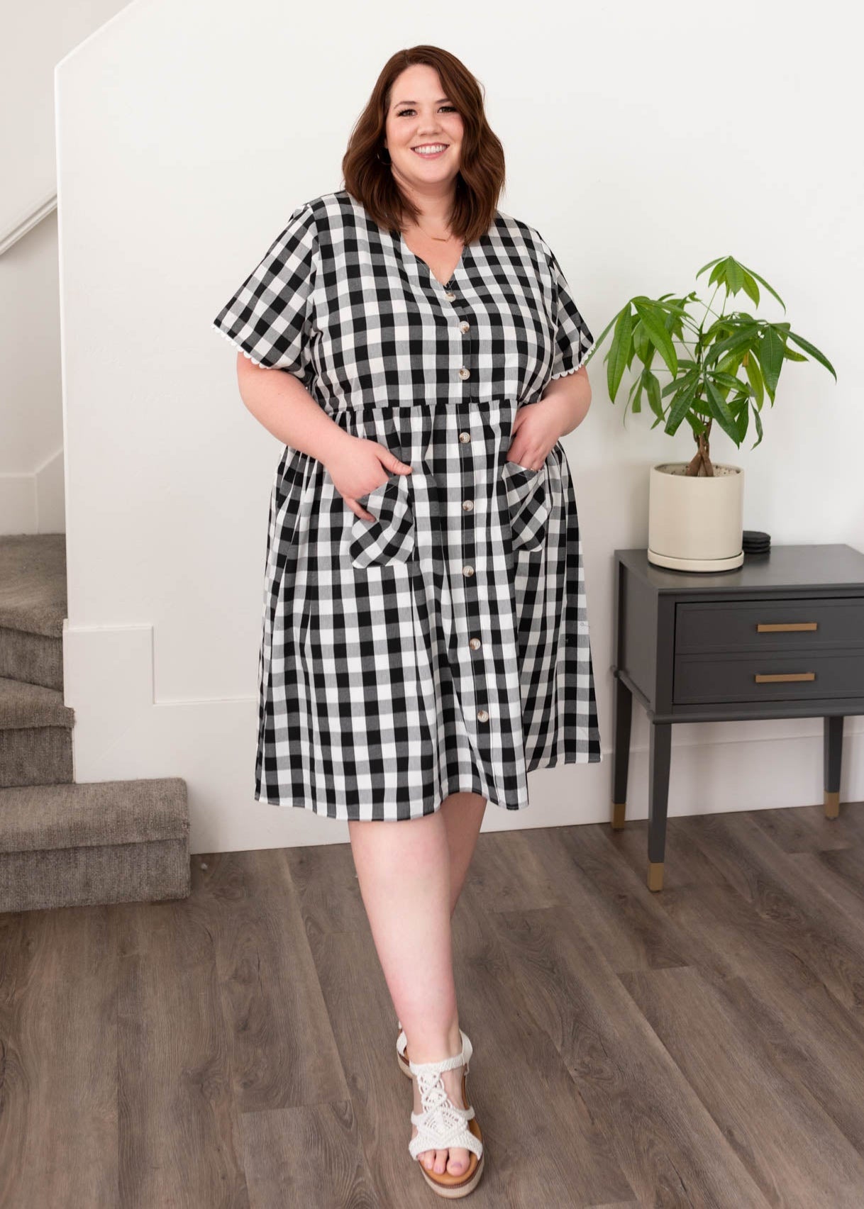 Plus size black gingham button dress with front pockets and v-neck