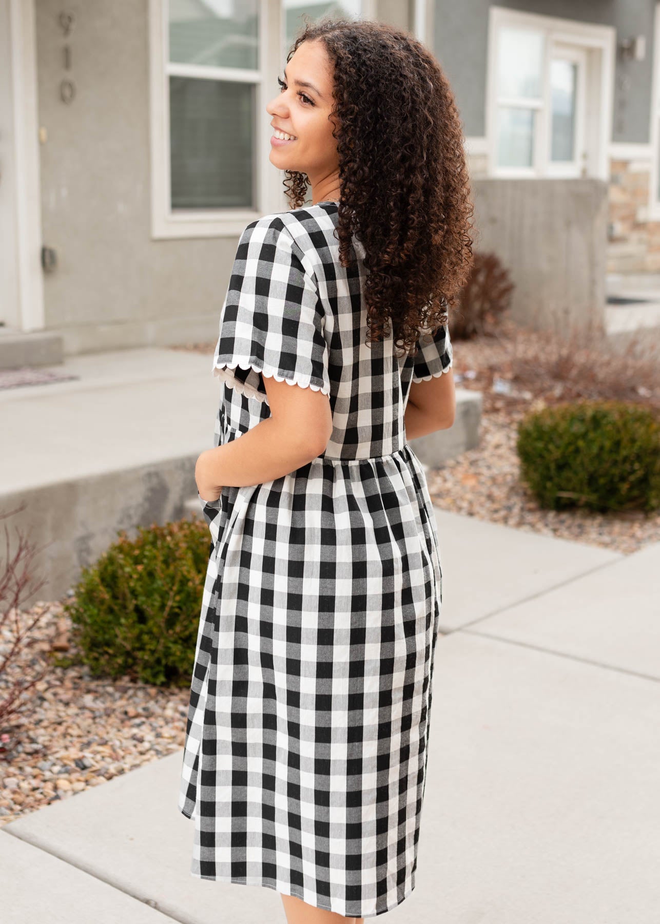 Side view of the black gingham button dress