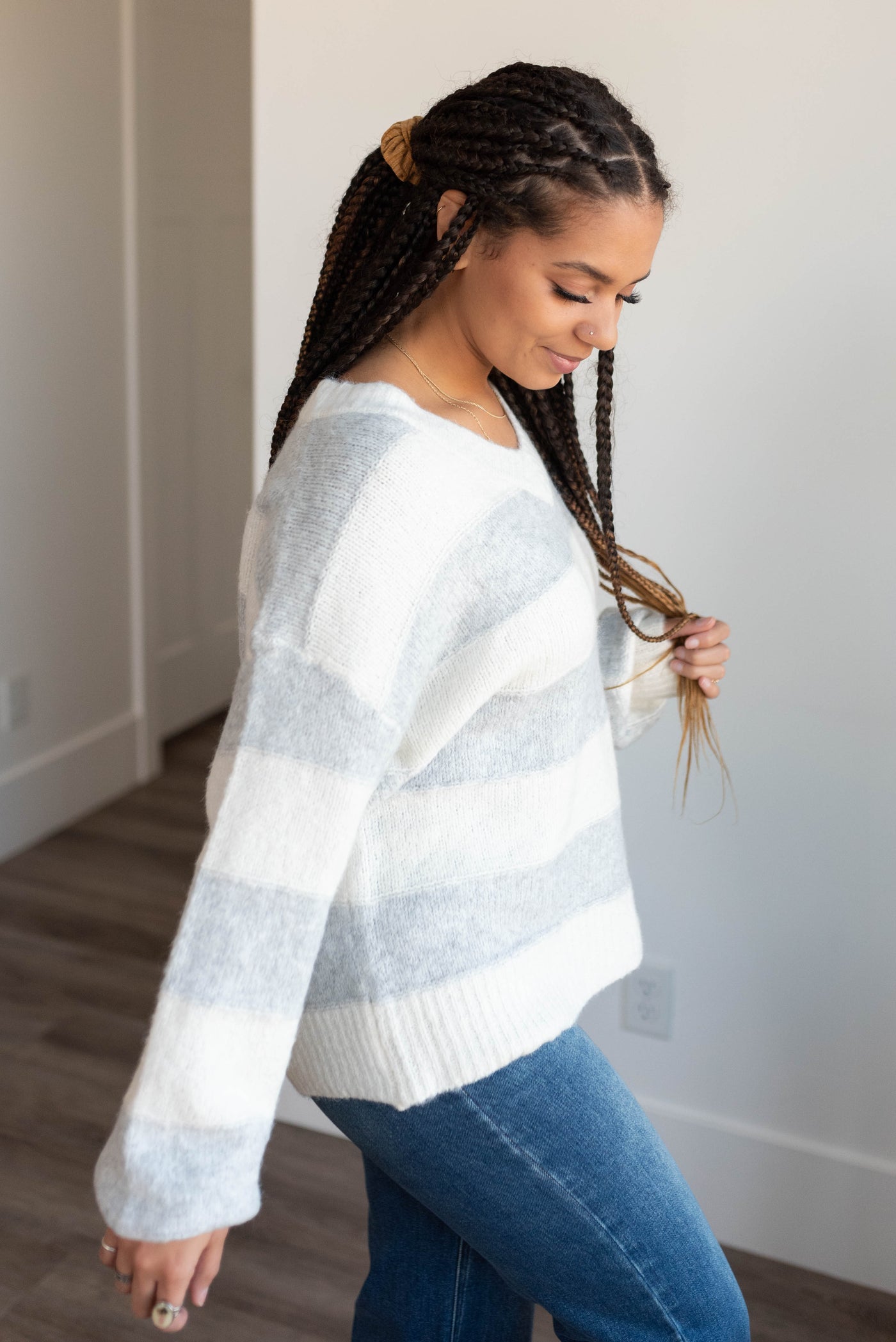 Side view of the grey stripe sweater