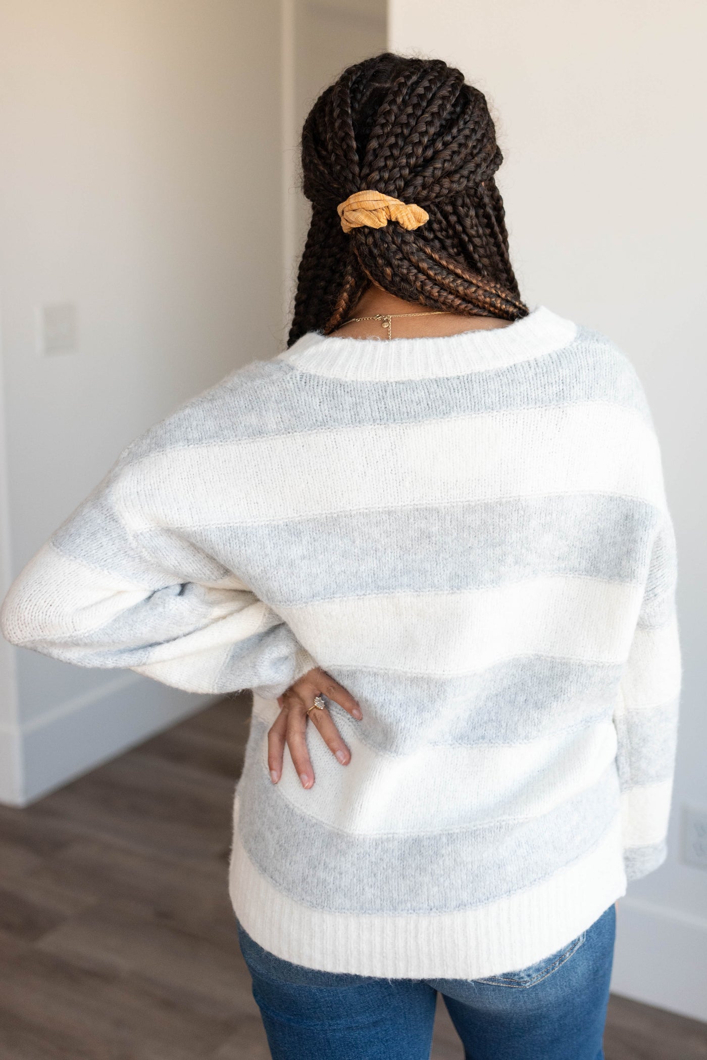 Back view of the grey stripe sweater