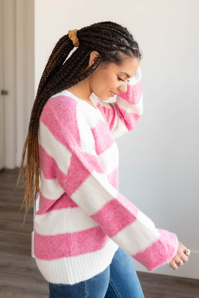 Side view of the pink stripe sweater