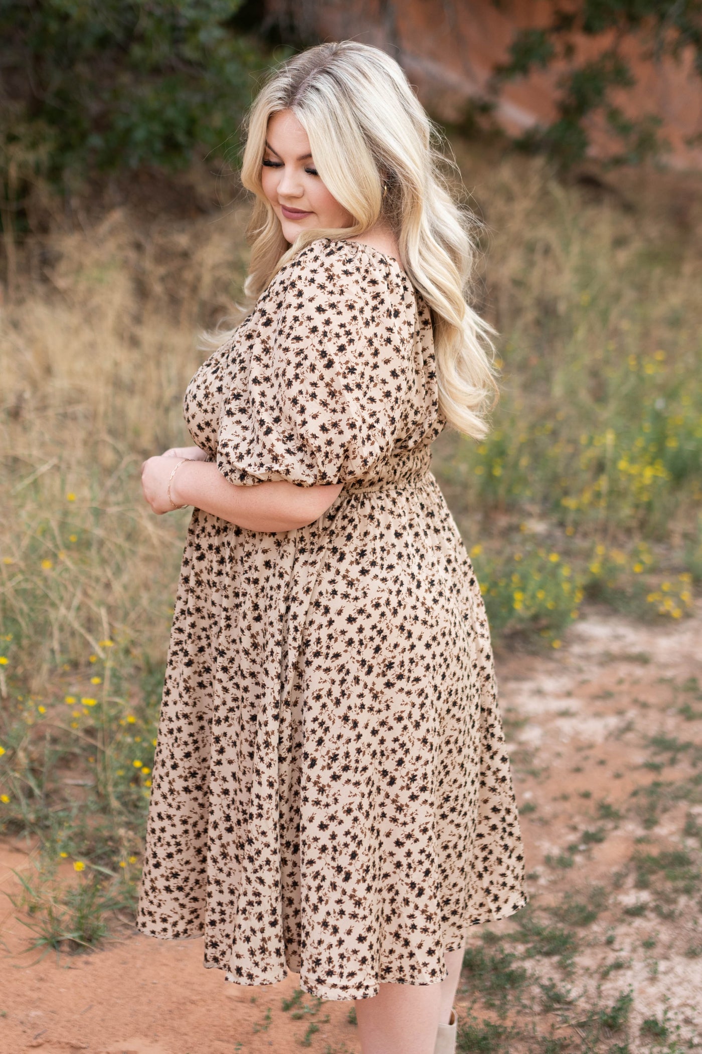 Side view of a plus size brown floral dress