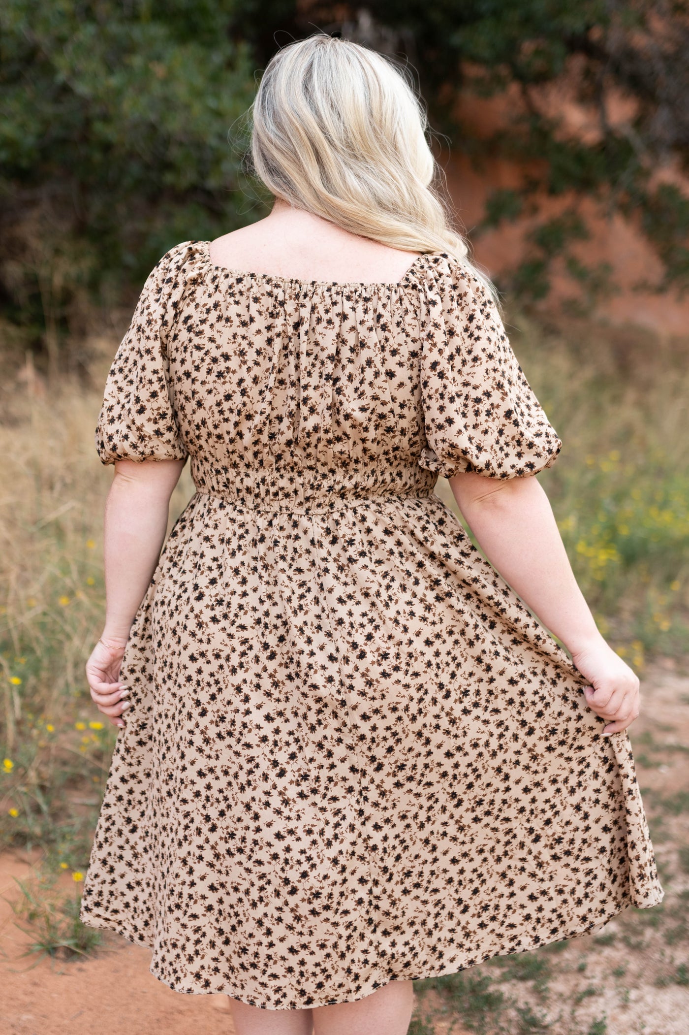 Back view of a plus size brown floral dress