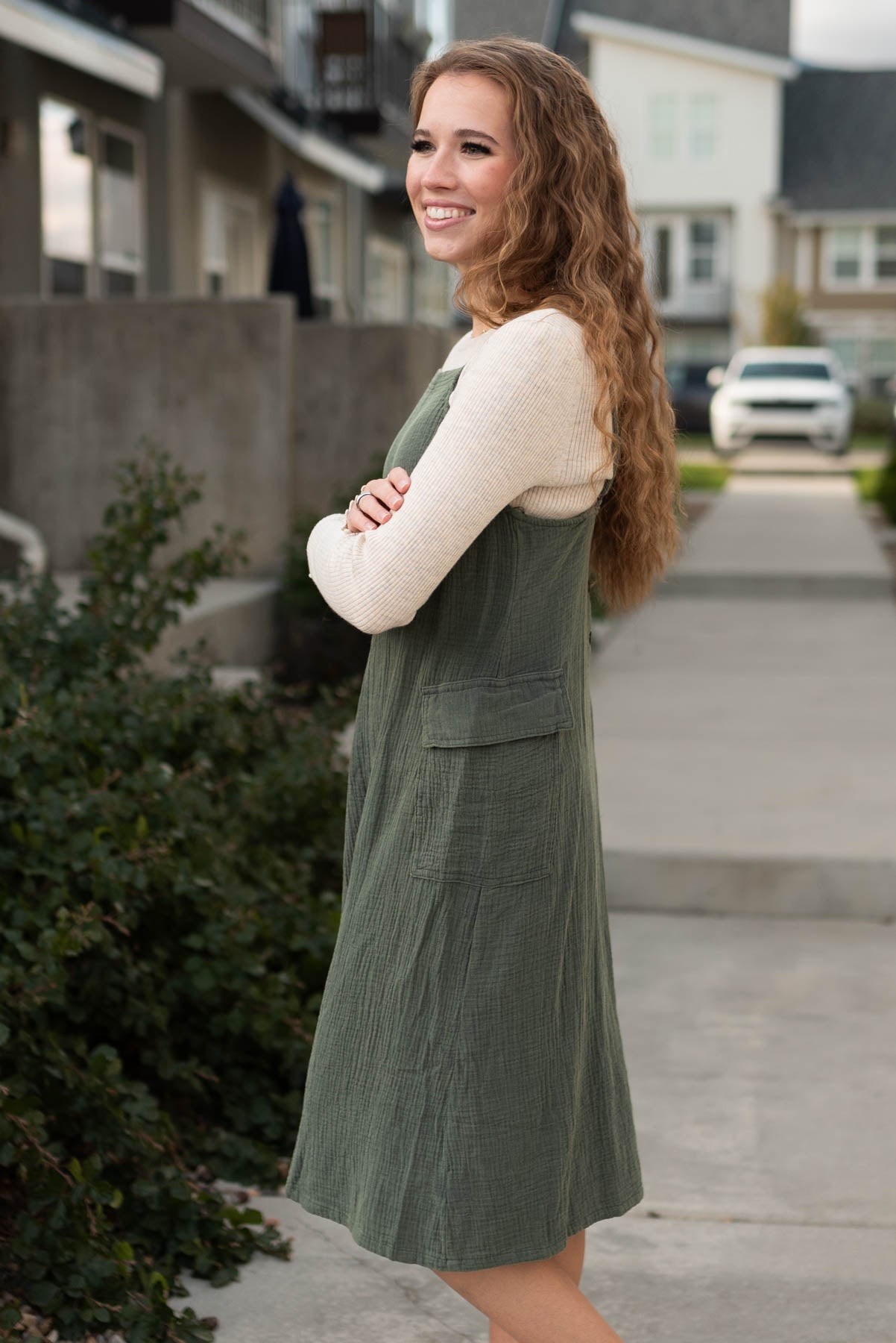 Side view of the dark olive dress with side pockets